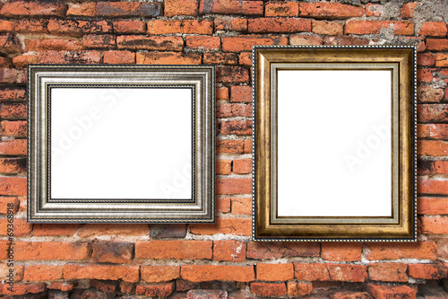 Golden wood frame on old brick background © littlestocker