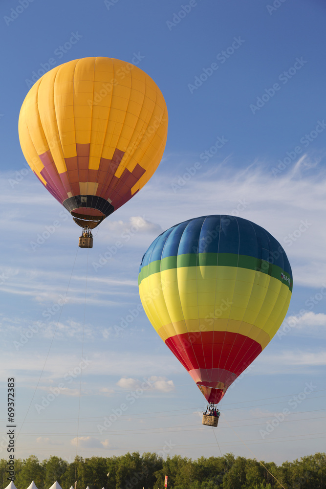 Flying balloons in blue sky
