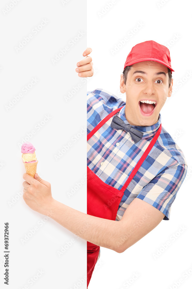 Excited male ice cream vendor posing behind a panel