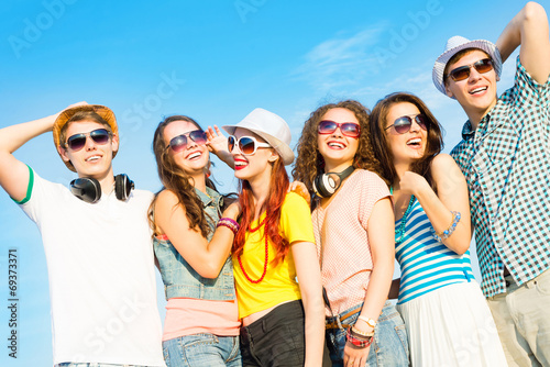 group of young people wearing sunglasses and hat