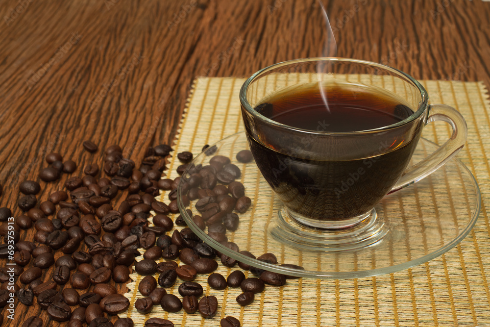 Coffee cup and coffee beans on old wooden background Coffee cup and coffee beans on old wooden background