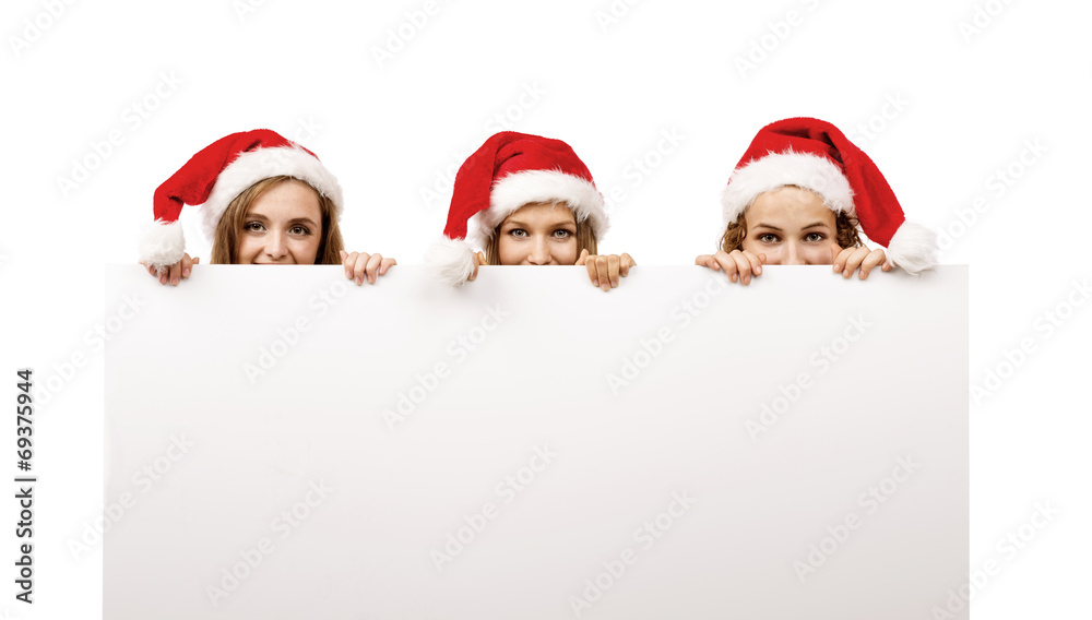 Young women in santa hats Young women in santa hats