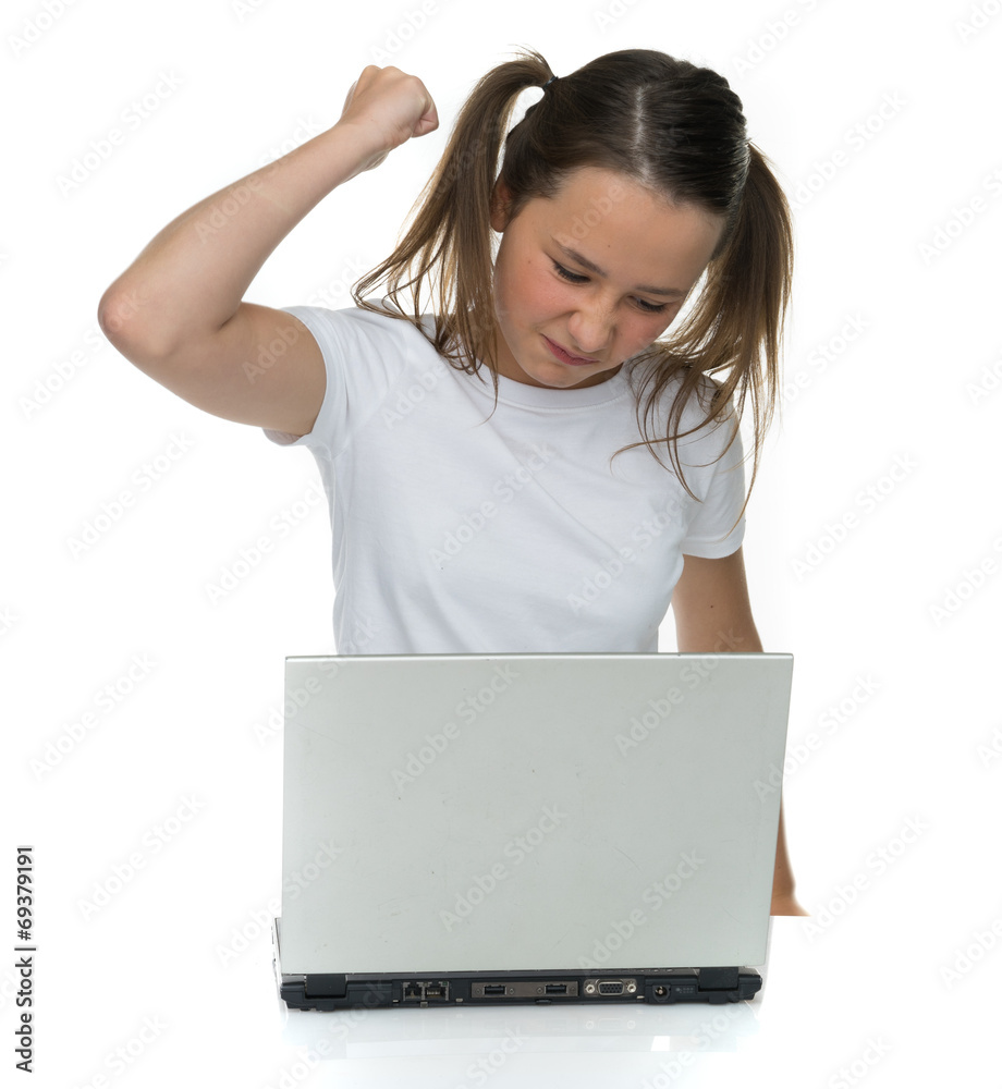 Angry young girl attacking her laptop computer Angry young girl attacking her laptop computer