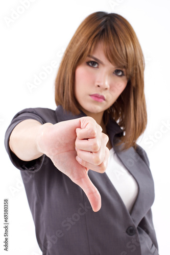 angry businesswoman giving, showing thumb down hand gesture photo