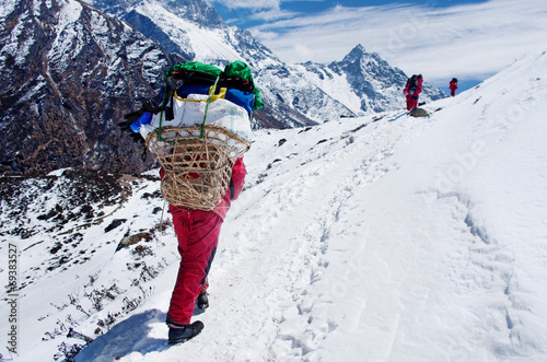Porters with heavy load,  Nepal