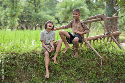 Little boy and girl farmer on green fields.