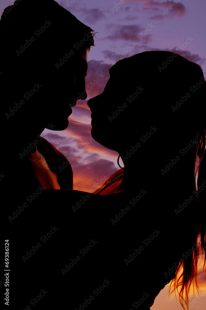 silhouette couple heads close almost to kiss