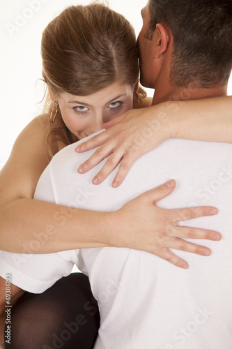 woman arms around mans shoulders looking