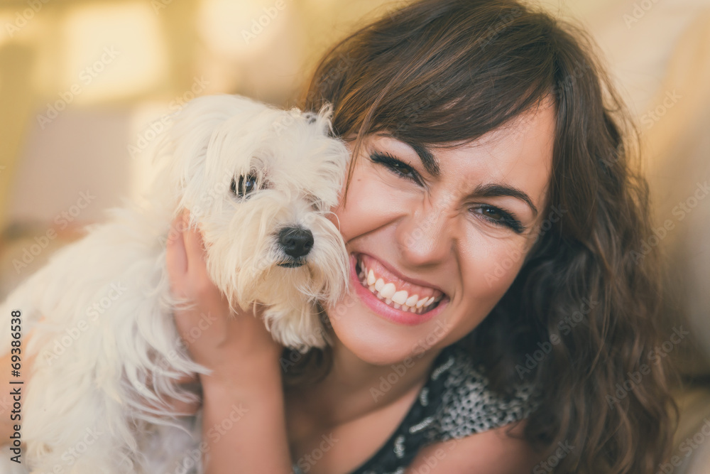 Happy smiling woman cuddling her pet dog Happy smiling woman cuddling her pet dog