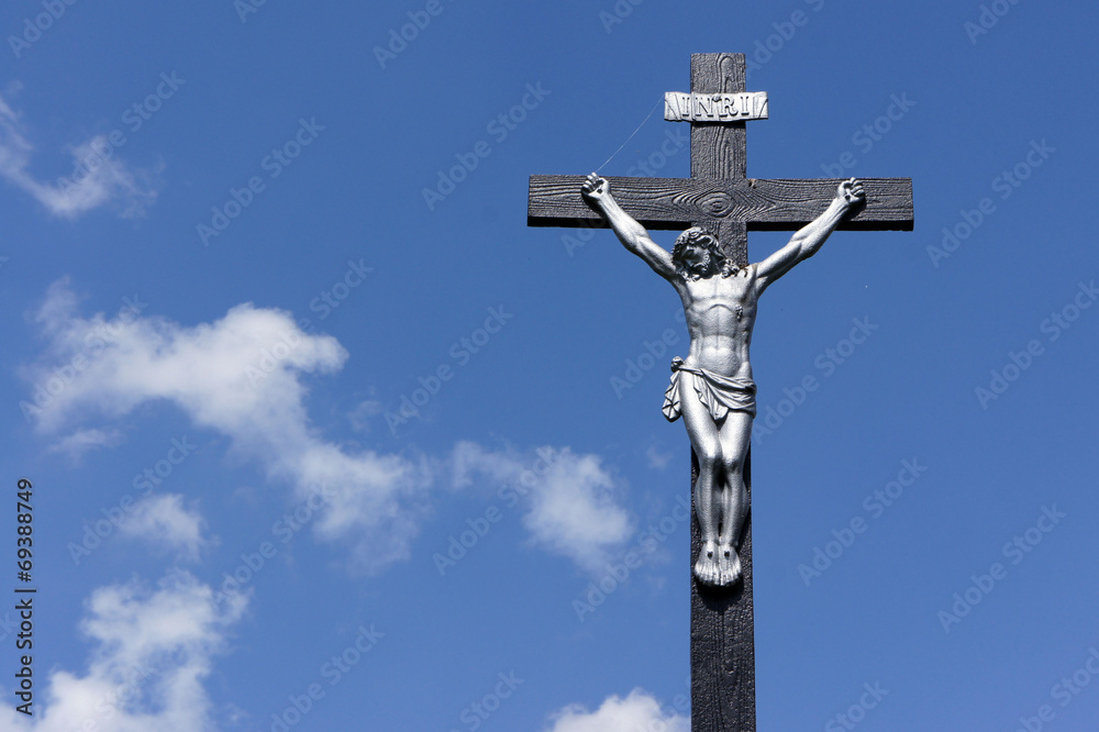 Jesus on the cross against a blue sky