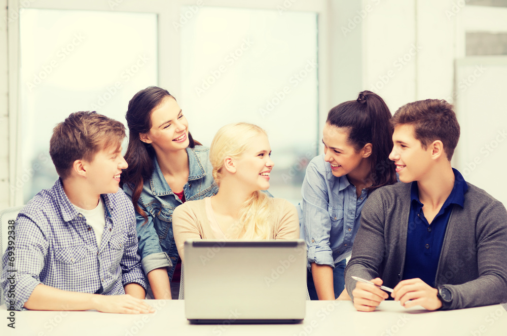 smiling students with laptop at school smiling students with laptop at school