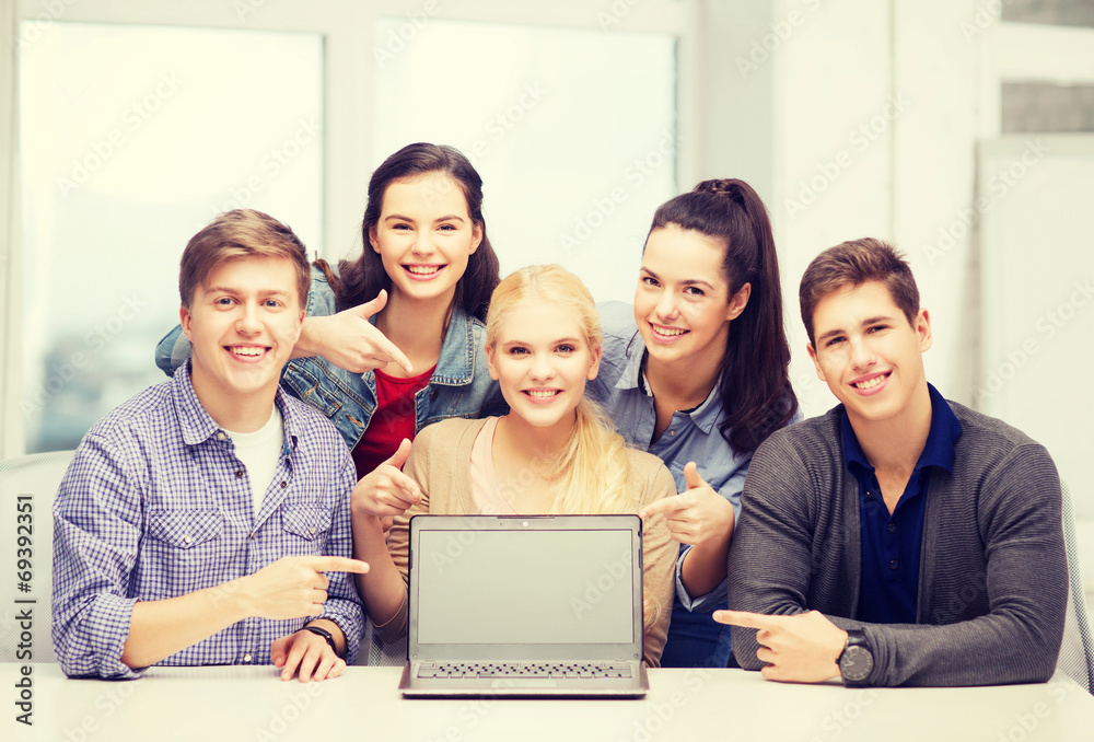 smiling students pointing to blank lapotop screen smiling students pointing to blank lapotop screen