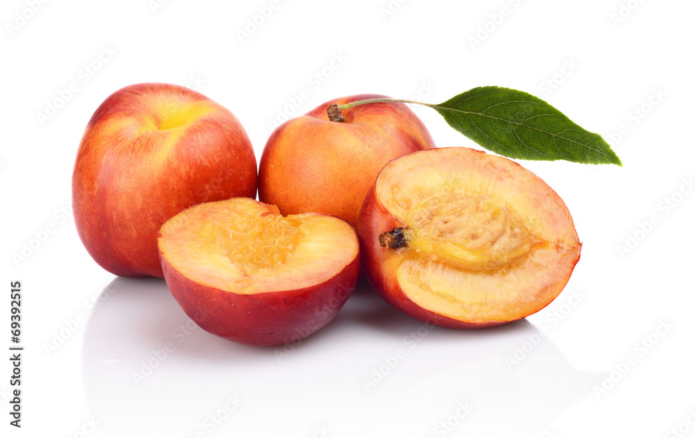 Few sliced nectarines with leaf isolated on white Few sliced nectarines with leaf isolated on white