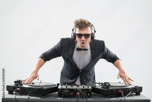 DJ in tuxedo mixing by turntable