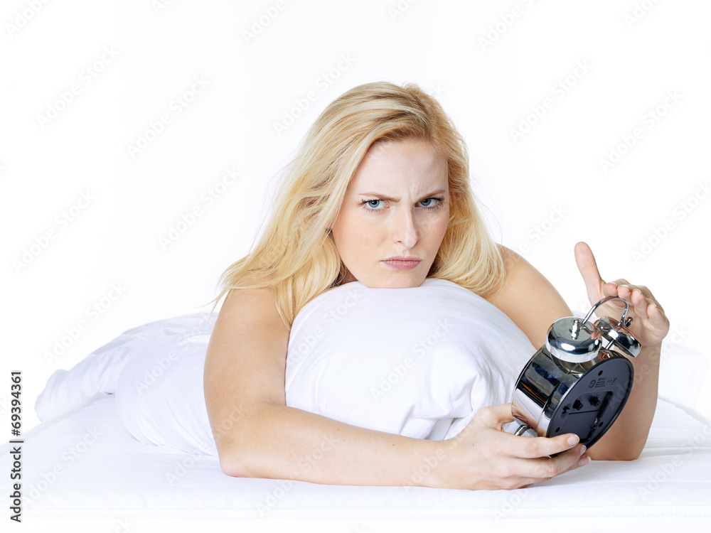 Woman with alarm clock awakes in the morning Woman with alarm clock awakes in the morning