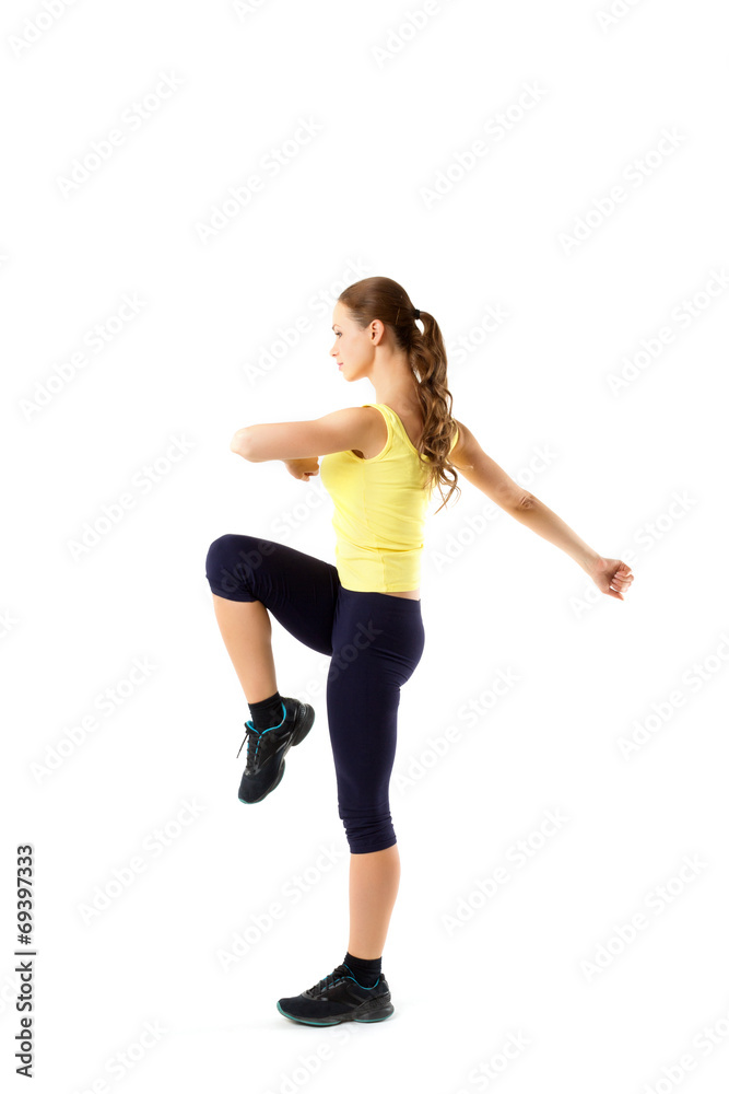 Young beautiful woman posing in a gym outfit.