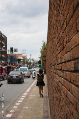 Girl Walking Along A Wall On The Sidewalk © skywalker_ll