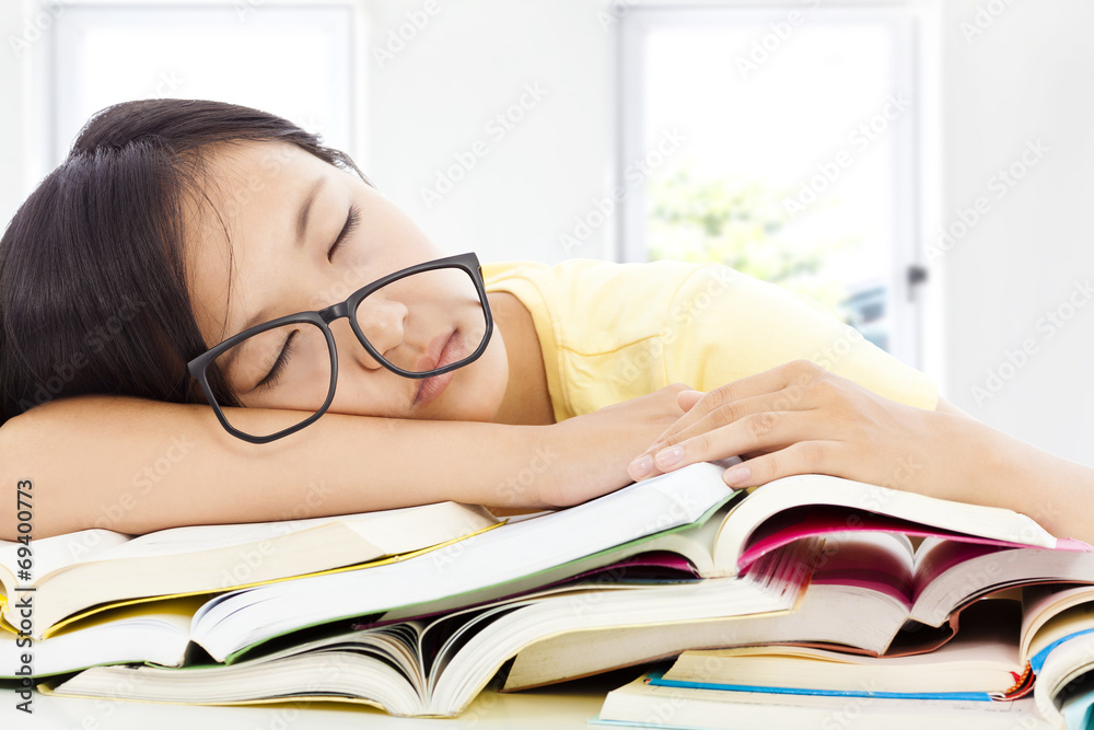 tired student girl with glasses sleeping on the books tired student girl with glasses sleeping on the books