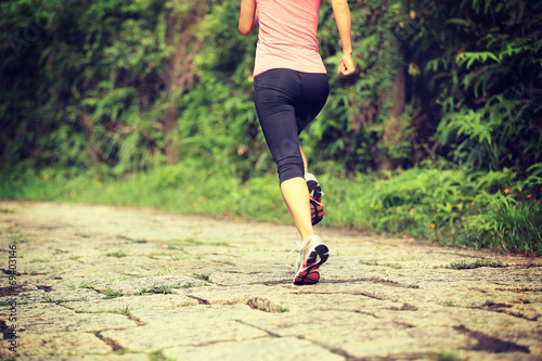 fitness woman runner running on stone trail