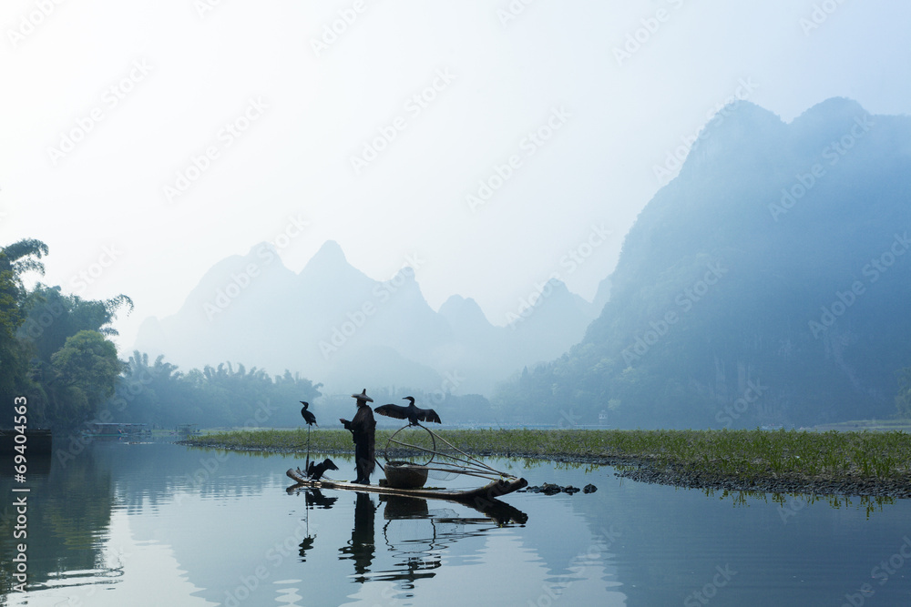 Cormorant, fish man and Li River scenery sight with fog in sprin