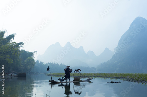 Cormorant  fish man and Li River scenery sight with fog in sprin