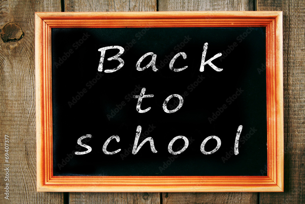 Back to school. The frame on wooden background.