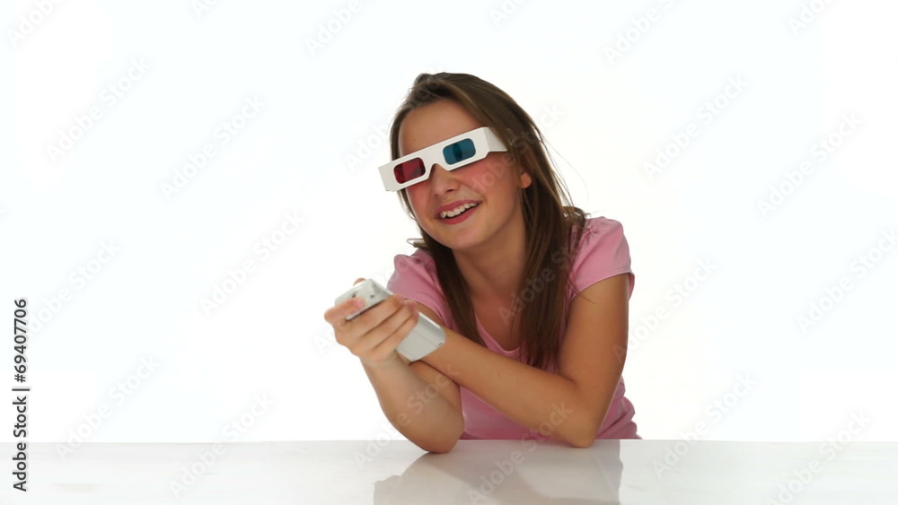 Young girl in 3d glasses with a remote control Young girl in 3d glasses with a remote control