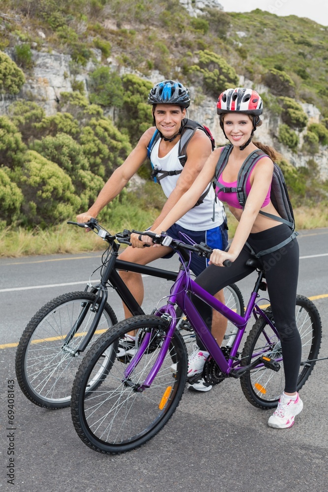 Fototapeta premium Athletic couple mountain biking