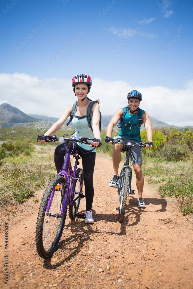 Fototapeta premium Athletic couple mountain biking