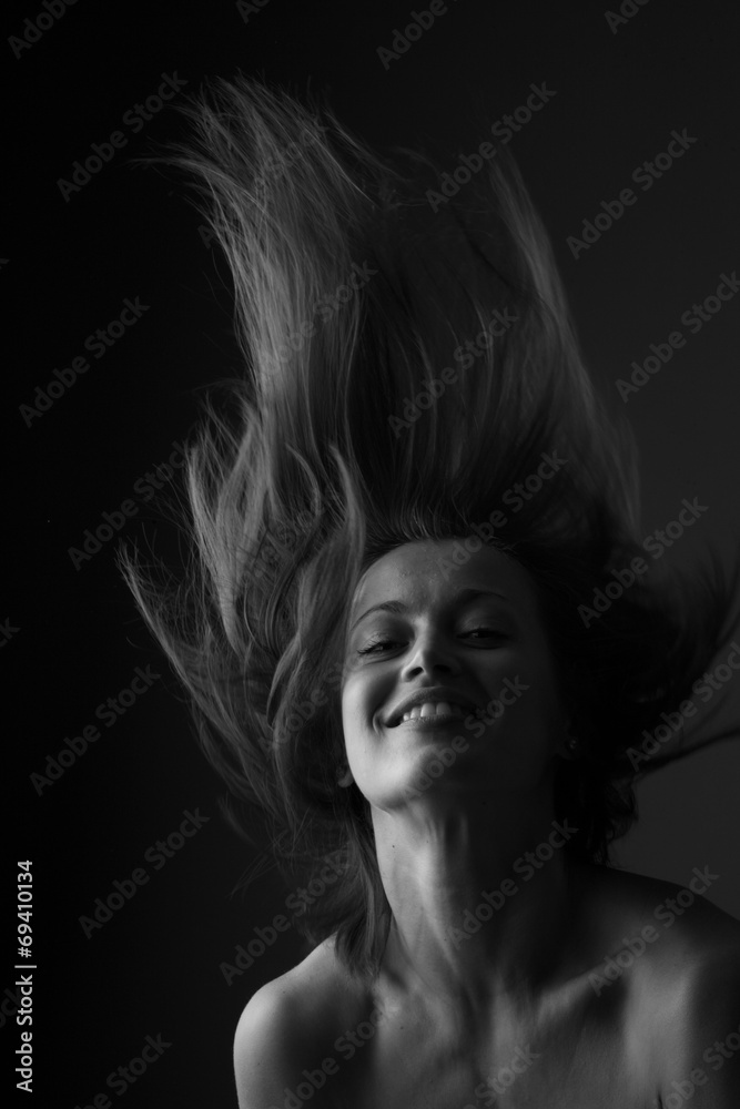 Happy beautiful woman shaking head; monochrome