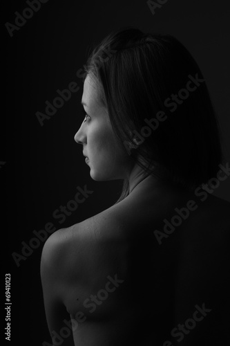 Portrait of beautiful woman sitting with a bare back
