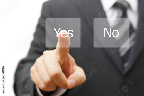 businessman pressing yes virtual button