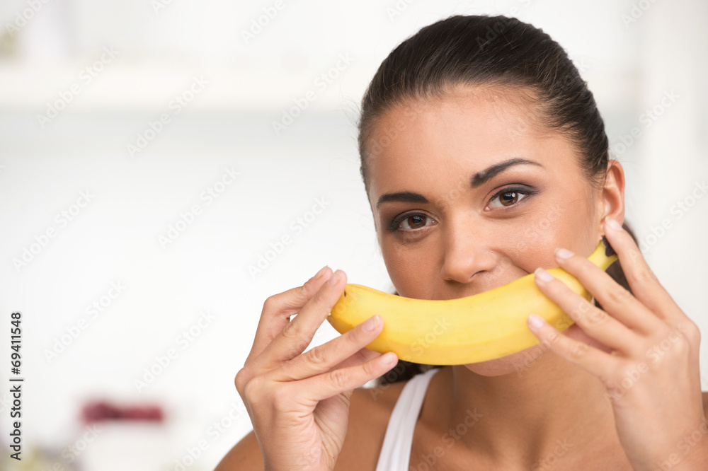 creative portrait of woman holding yellow banana in her hand. creative portrait of woman holding yellow banana in her hand.