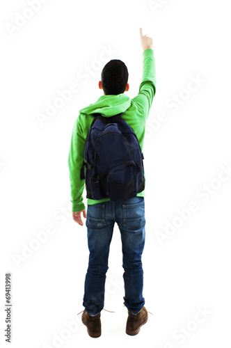 Young student with backpacks pointing at wall. Back view