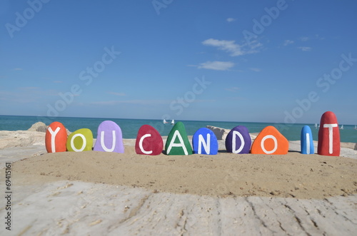 You can do it, colored stones composition on the sand