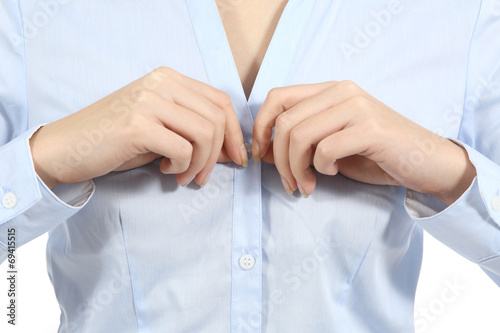 Closeup of a woman hands unbuttoning a shirt