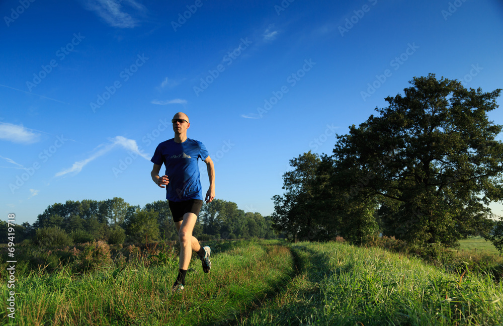 Man trail running in the countryside