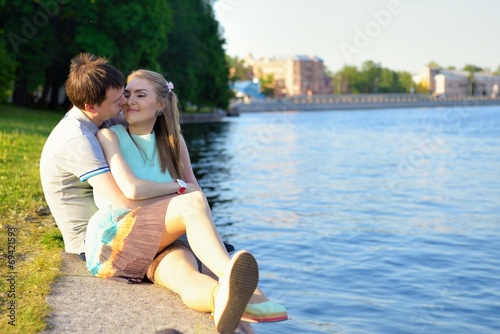 Portrait of a young in love couple on the embankment
