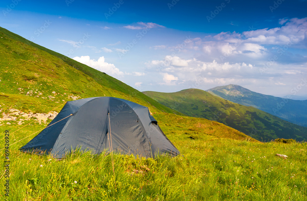Tourists tent in mountains