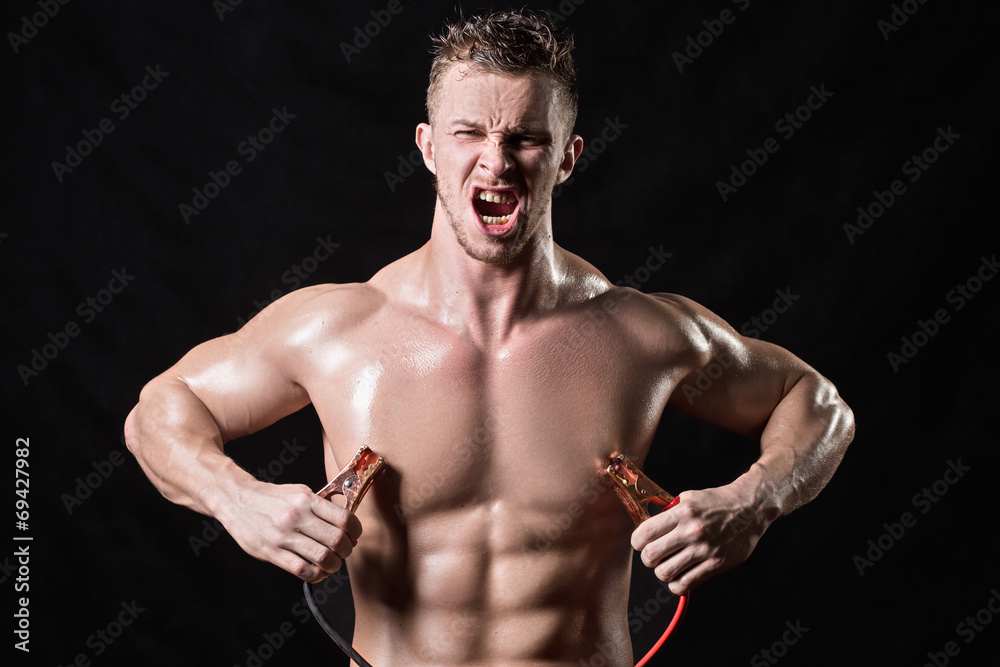 Obraz premium athlete holds the high voltage wires.