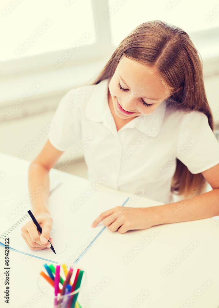 little student girl drawing at school little student girl drawing at school