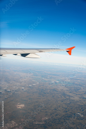 Airplane wing out of window © Elnur