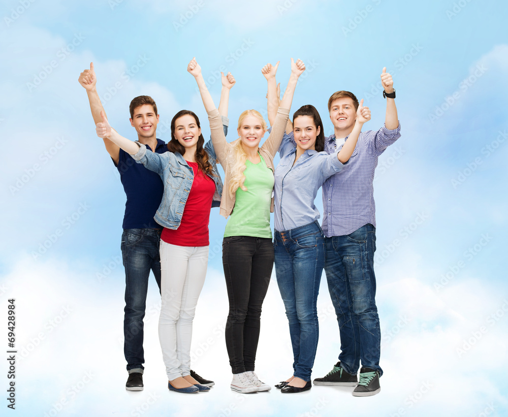 group of smiling students showing thumbs up group of smiling students showing thumbs up