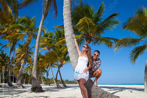 Vacation couple relaxing on beach together in love