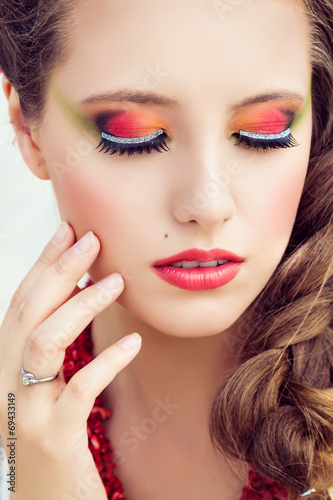 Beauty portrait of girl with pink lips and orange eyes shadows