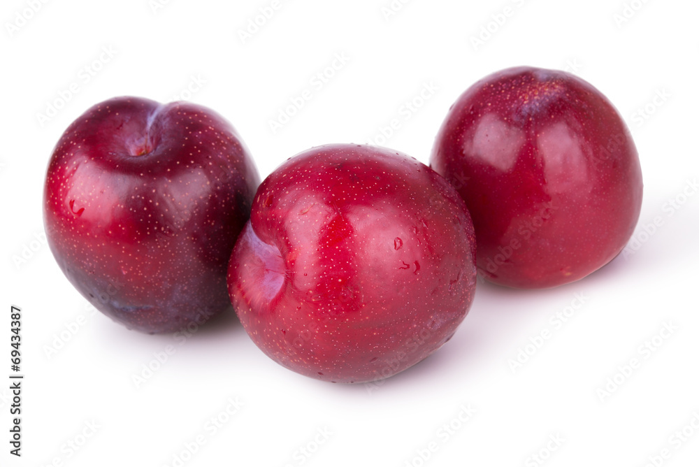 three juicy ripe plums