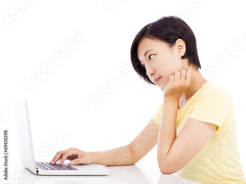 unhappy woman in front of a laptop, isolated on white background