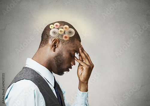 Man thinking hard, gear mechanisms over head, brain power photo