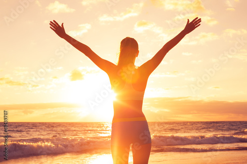 Happy Free Woman at Sunset on the Beach