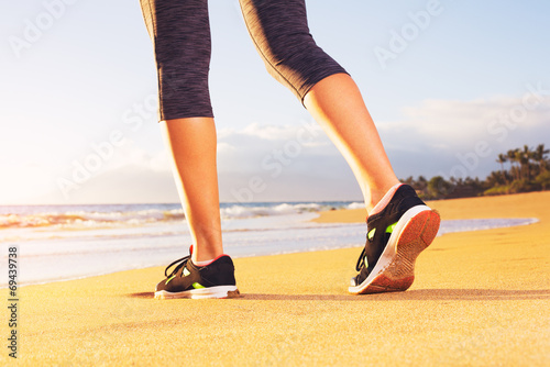 Athlete runner feet on the beach